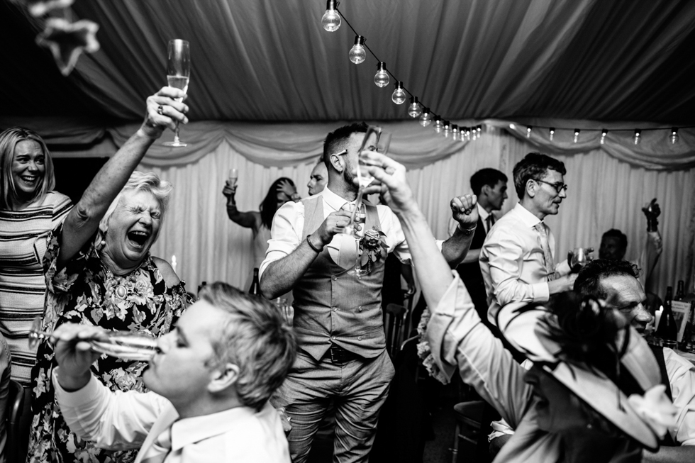 celebrating with champagne at the end of the wedding speeches
