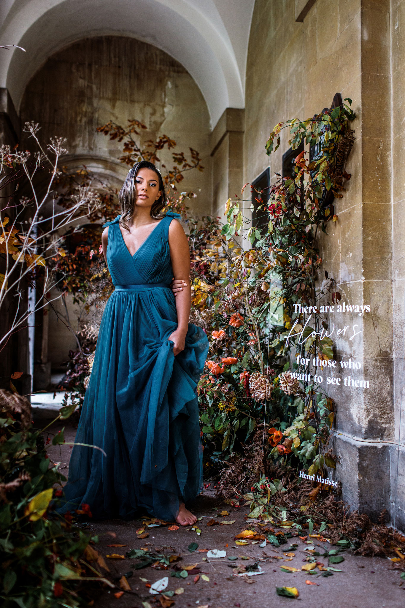 bride wearing a floaty green THTH bridesmaids dress surrounded my florals for a small different wedding in bath