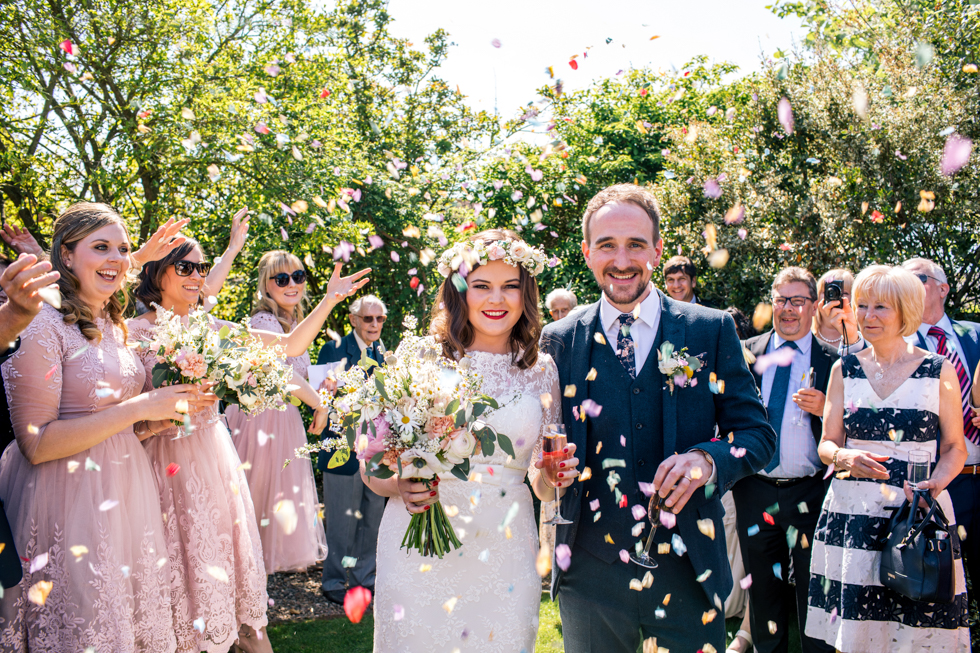loads of confetti in the couples face at the Curradine Barns near Worcestershire