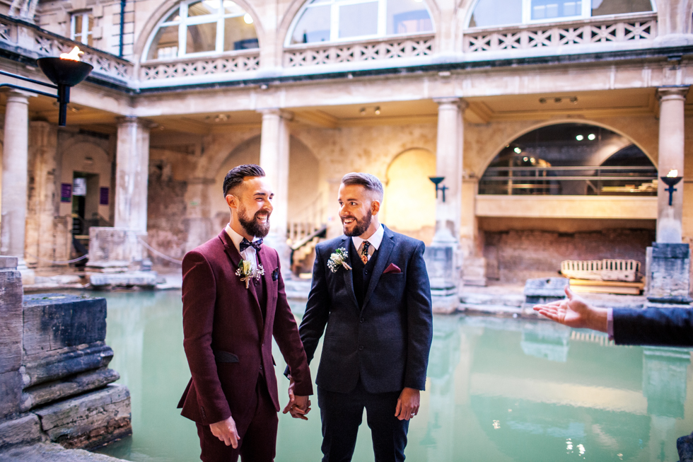 gay wedding at Roman baths stood right by the water at twilight