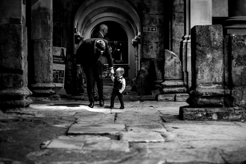 18 month toddler walking into ceremony room as ring bearer at Roman baths