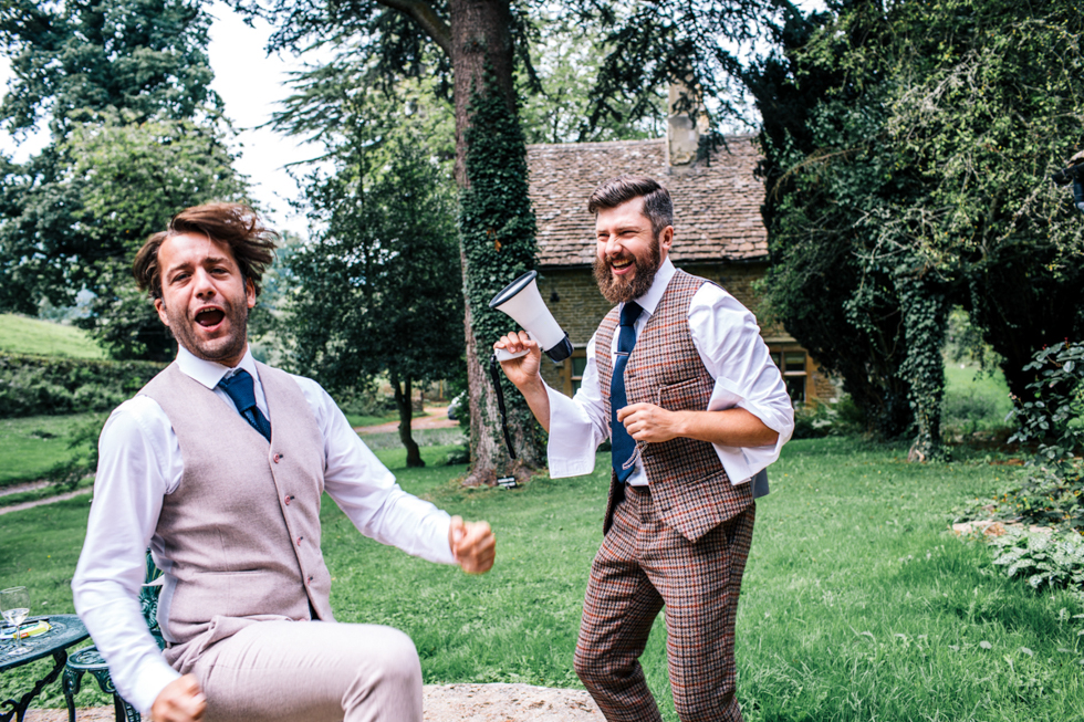 groom in tweed suit using megaphone and dancing whilst getting ready at owlpen manor