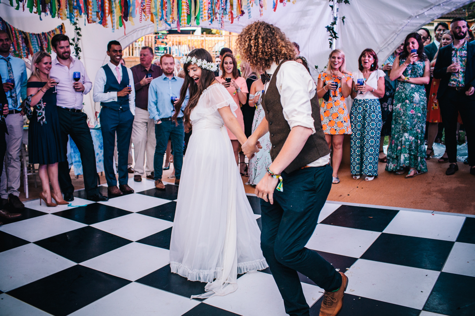 bohemian bride and groom first dance at the main stage Glastonbury style wedding