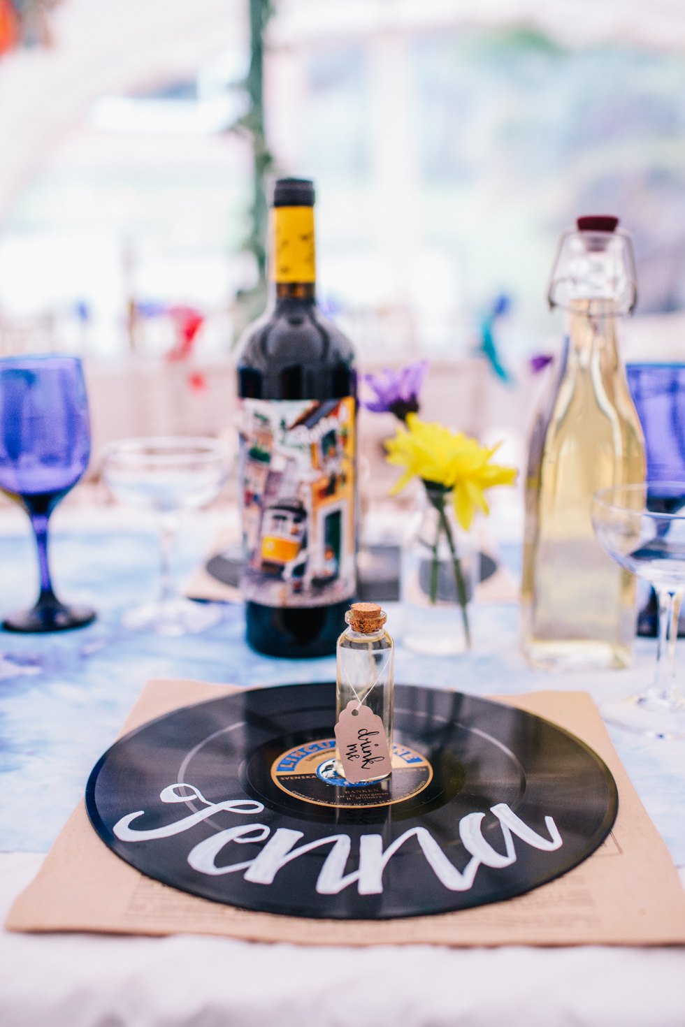 hand drawn calligraphy on vinyl records for place names at festival wedding 