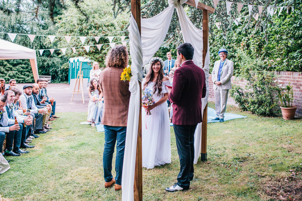 bride and groom at outdoor ceremony with brother as humanist celebrant