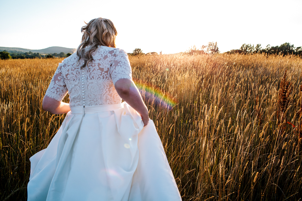 fun quirky bride and groom laughing in sunset at Quantock Lakes