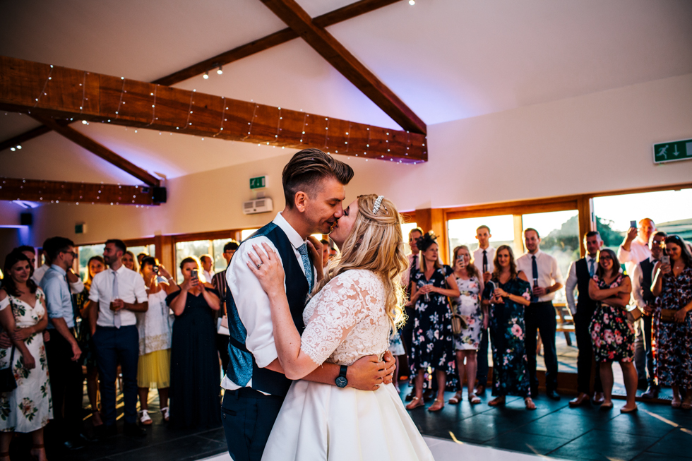 Bride and groom kissing on the dance floor during first dance at Quantock Lakes