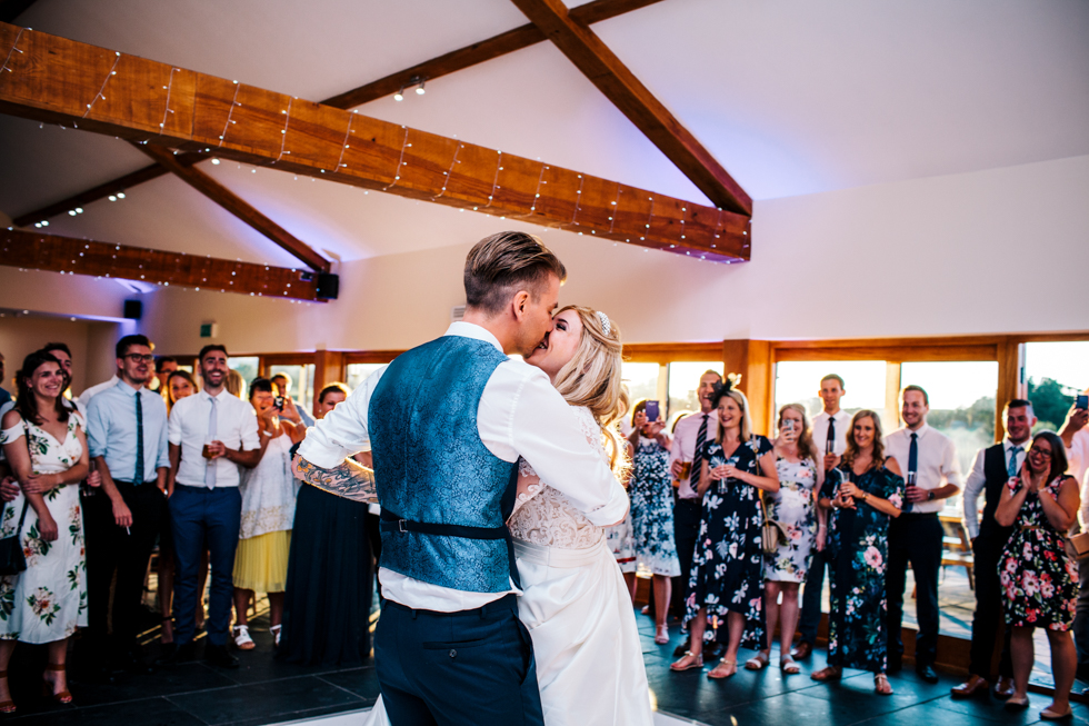 Bride and groom kissing on the dance floor during first dance at Quantock Lakes