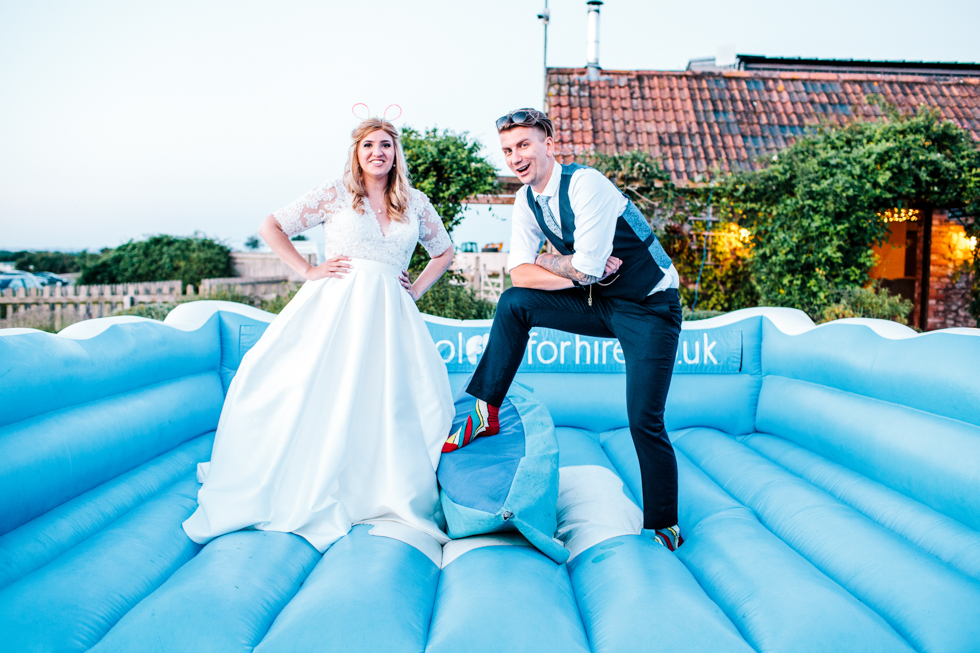 Bride and groom Standing for portrait on surfing machine at alternative wedding