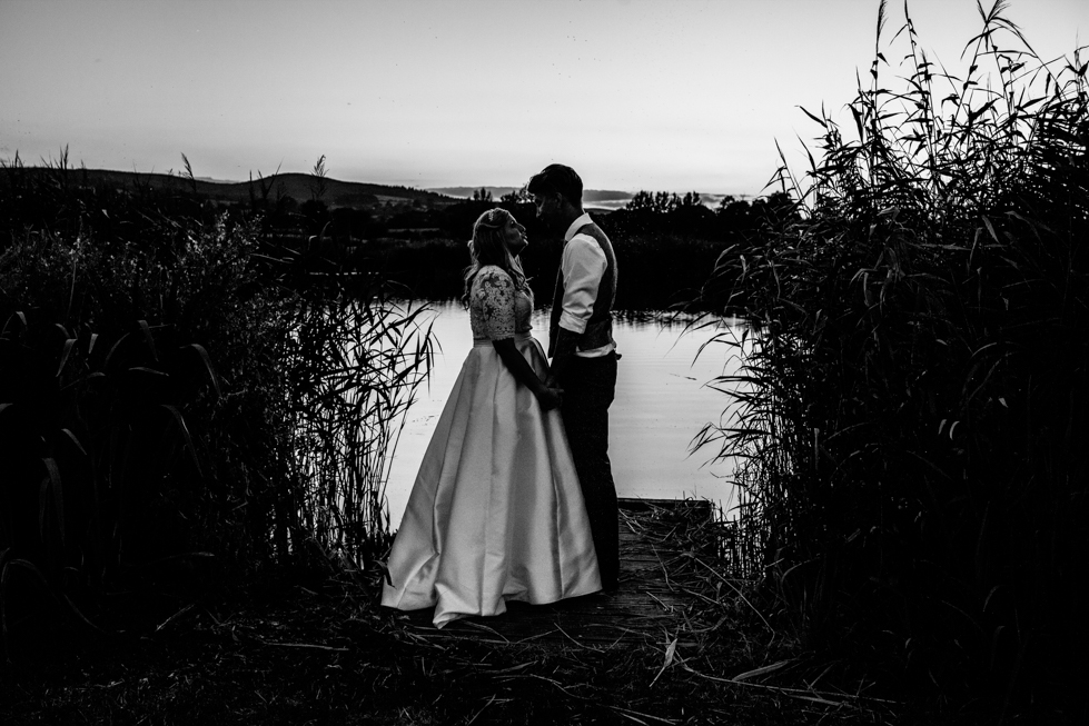 Bride and groom in sunset shot at Quantock Lake