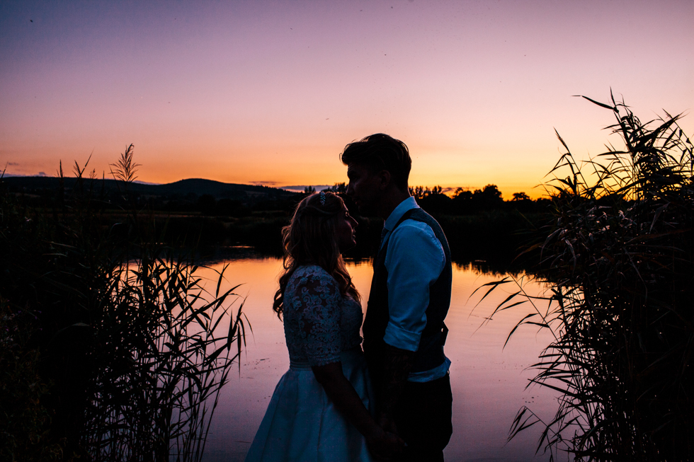 Bride and groom in sunset shot at Quantock Lake