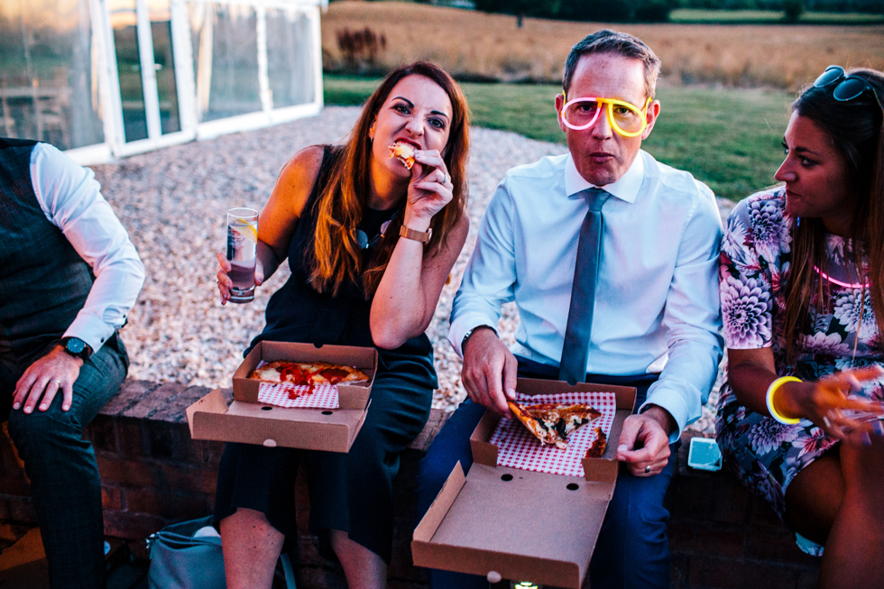Wedding guests eating pizza at the end of the night