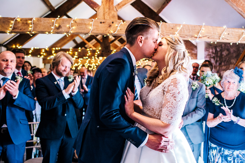 bride and groom kissing at wedding ceremony at Quantock Lakes