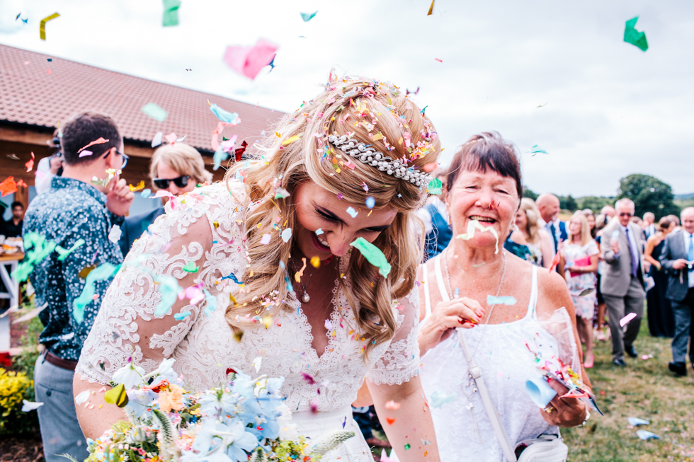 colourful confetti being thrown over alternative bride at Quantock Lakes