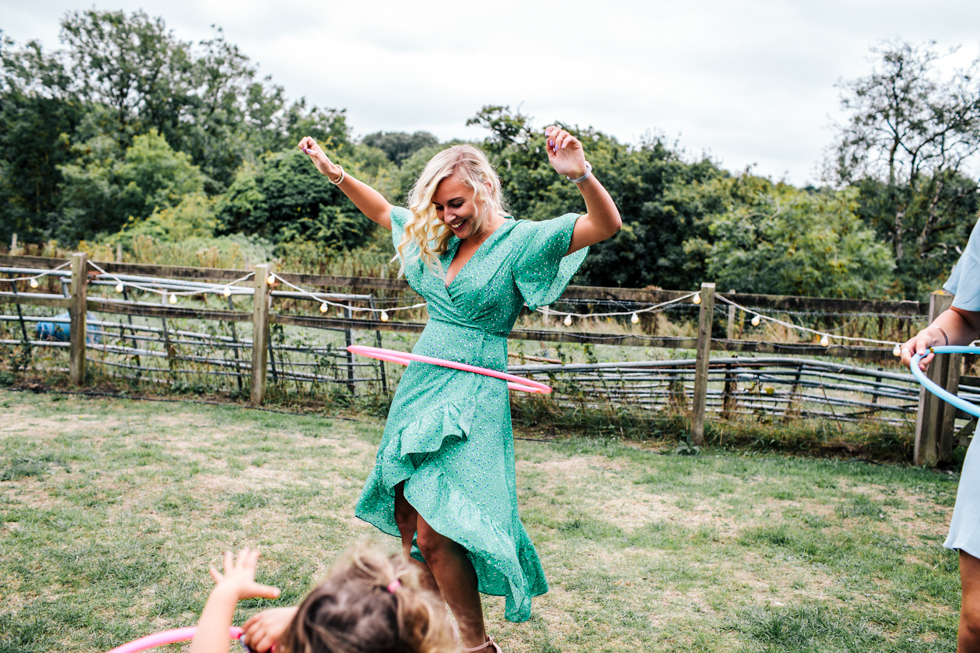 adults having fun with hula hoops at wedding